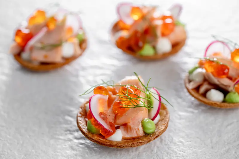 Tartlets topped with cured fish, radish, peas and orange roe, finished with dill by myCHEF Cape Town