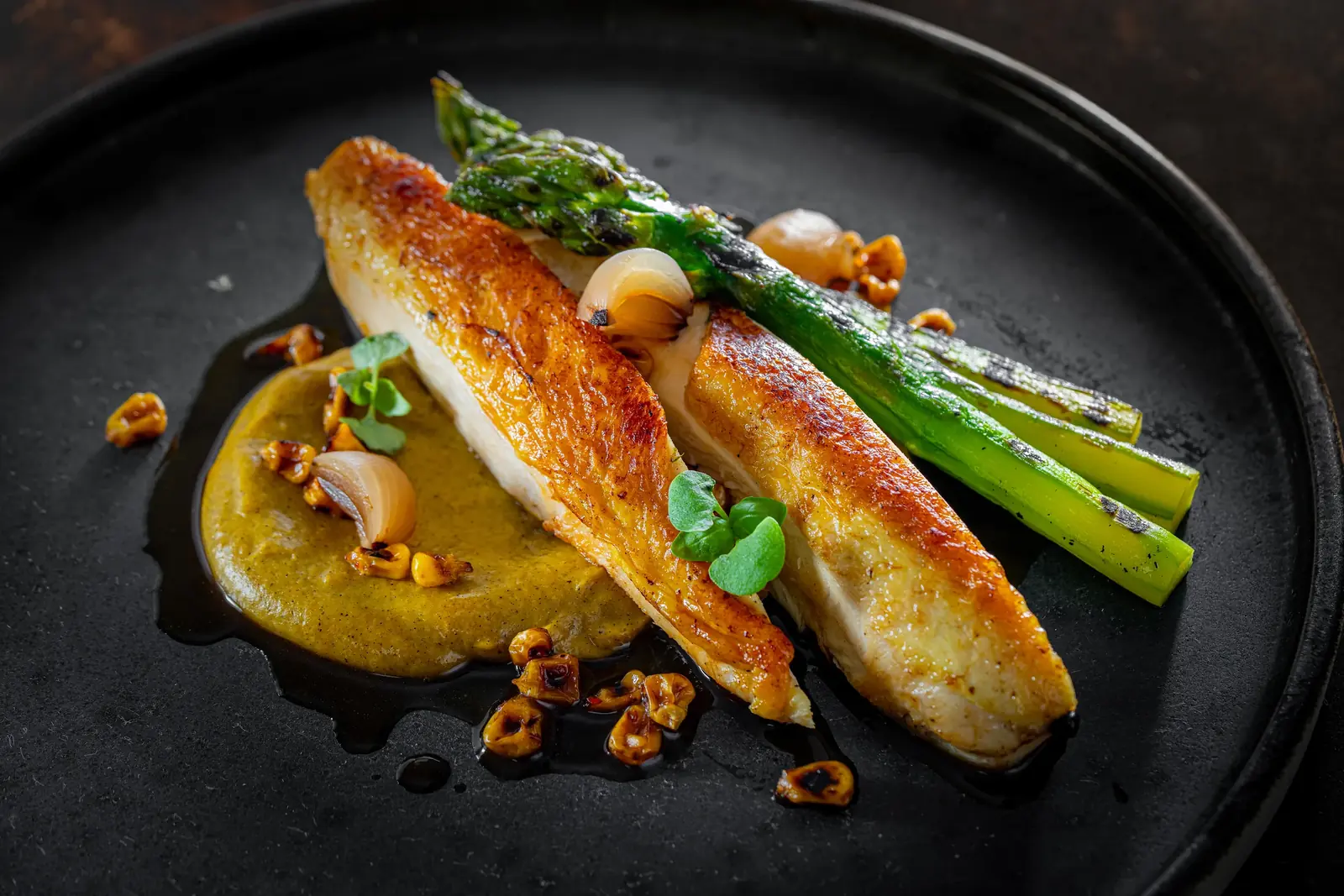 Roast chicken breast with grilled asparagus, a golden purée and toasted nuts, plated at a private chef dinner in Cape Town by myCHEF Cape Town